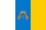 Flag of Canary Islands with blue and yellow vertical stripes and coat of arms in center
